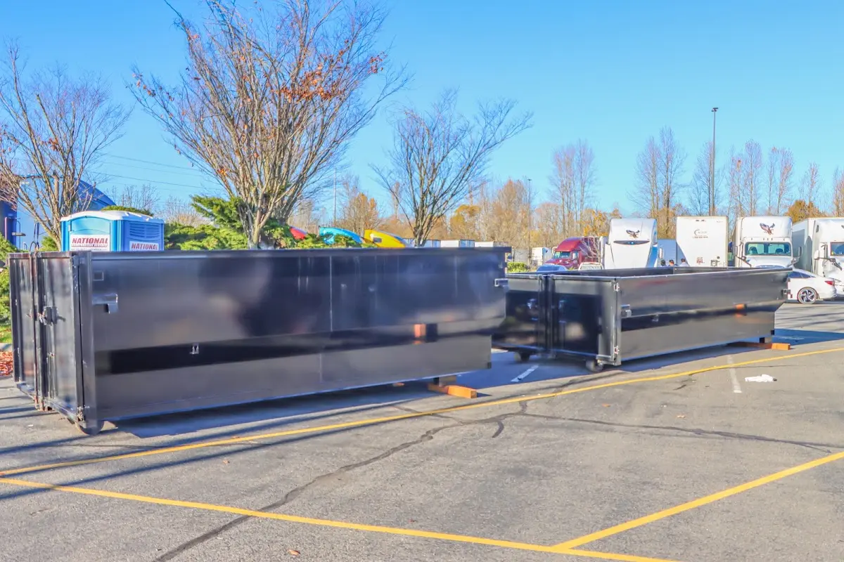 Professional dumpster rental service with roll-off container on residential driveway in North Vernon